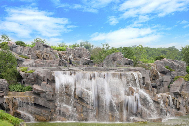 Great Falls Park over rocks with trees in the backgroundDescription automatically generated